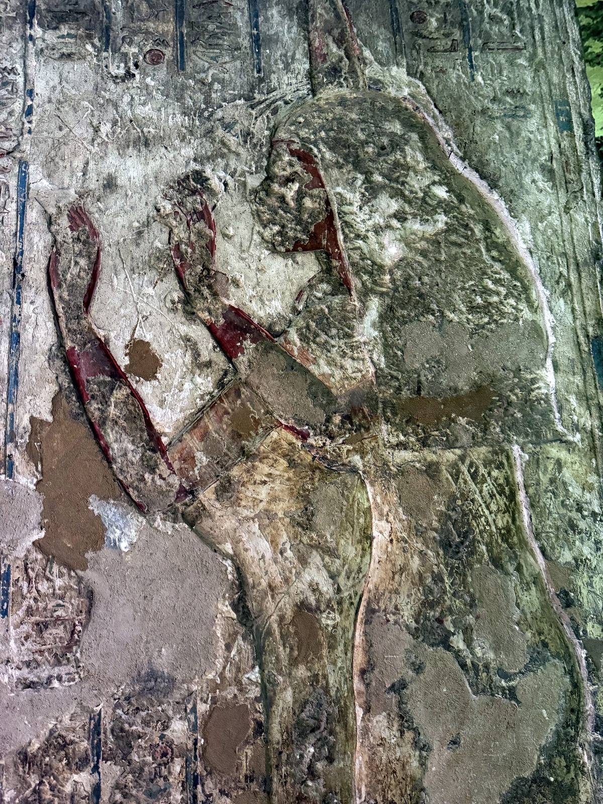 Painted relief traces on a rock-cut tomb wall at Amarna