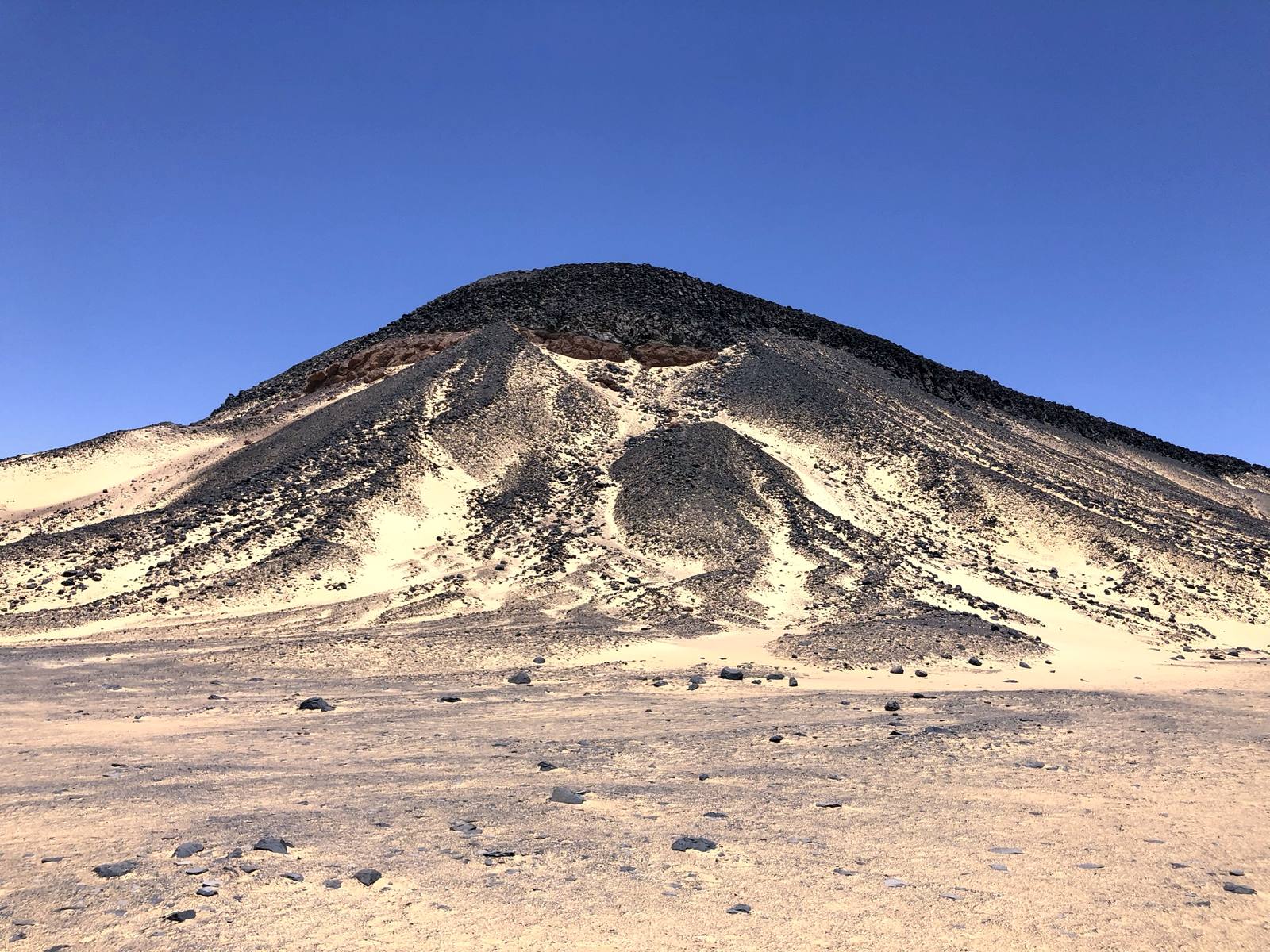 A basalt-capped hill rising from the Black Desert near Bahariya