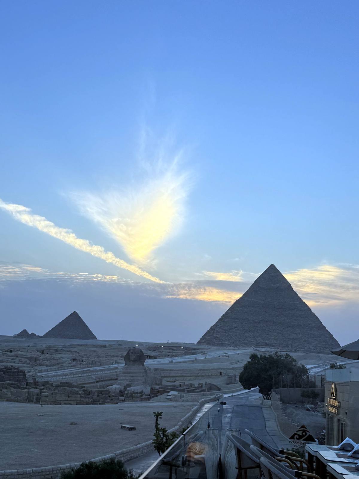 The pyramids of Giza beneath golden sunset clouds