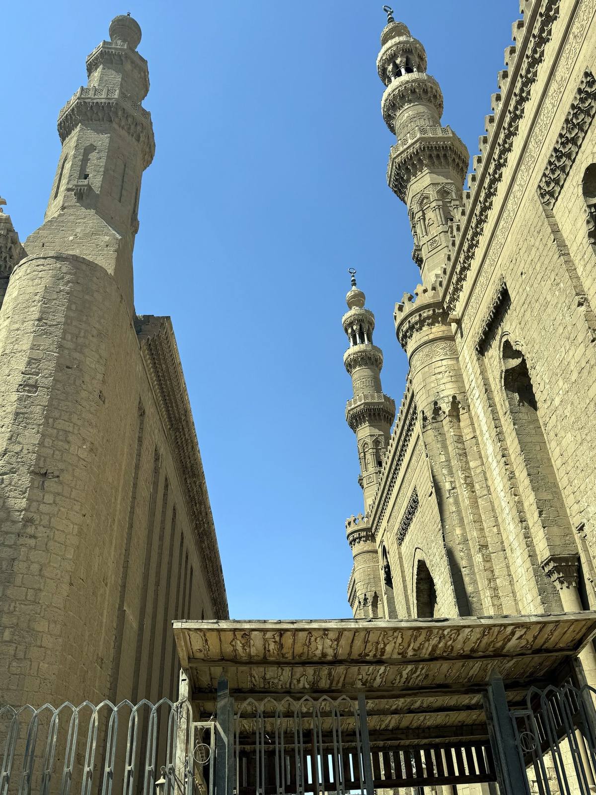 Minarets of the Sultan Hassan and Al-Rifa'i mosques against a blue Cairo sky