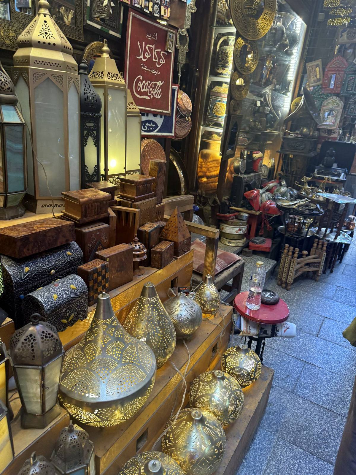 Pierced brass lanterns glowing at a stall in Khan el-Khalili bazaar