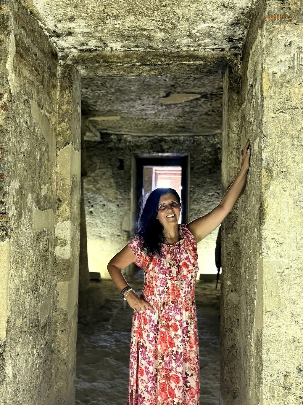 Kristina Mills standing in the ancient Tomb of Panehsy, Amarna