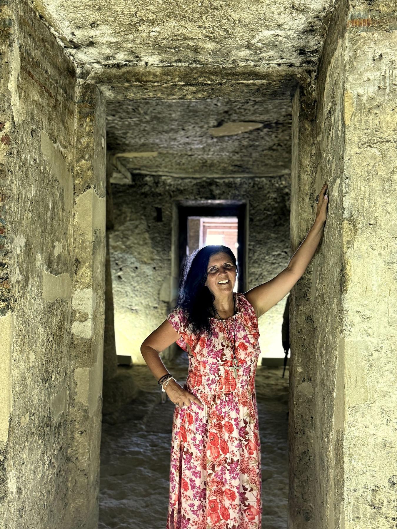 Kristina Mills standing in the ancient Tomb of Panehsy, Amarna