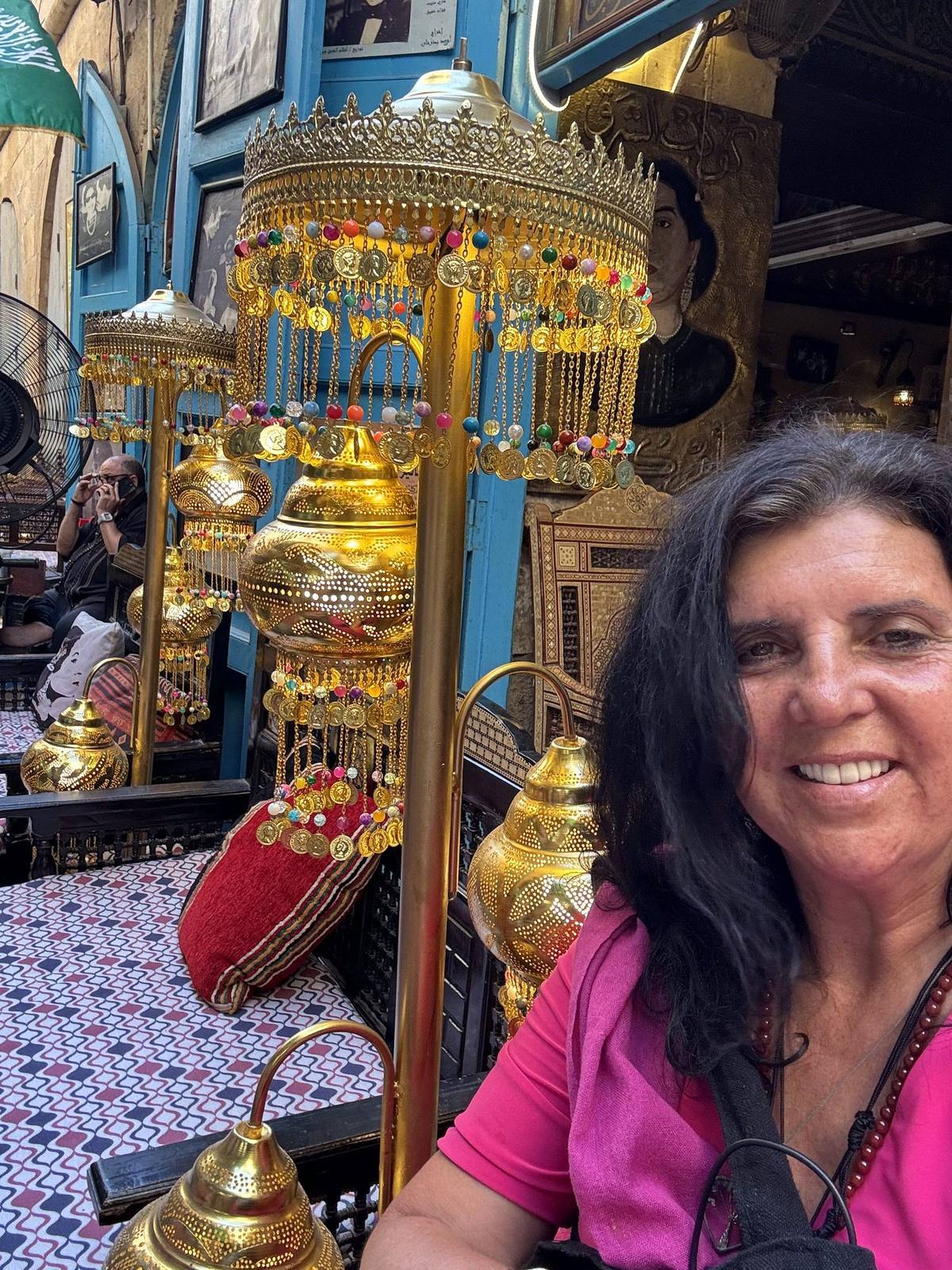 Kristina Mills beneath hanging lanterns in a Khan el-Khalili café