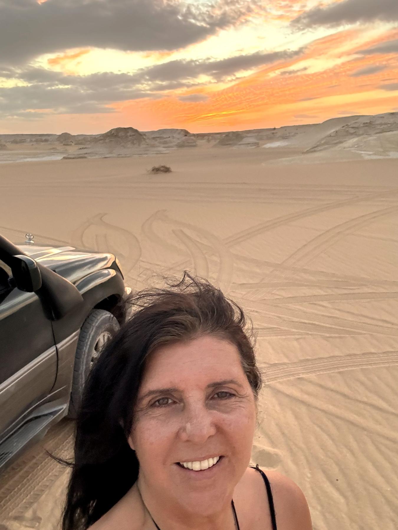 Kristina Mills smiling in the White Desert at sunset
