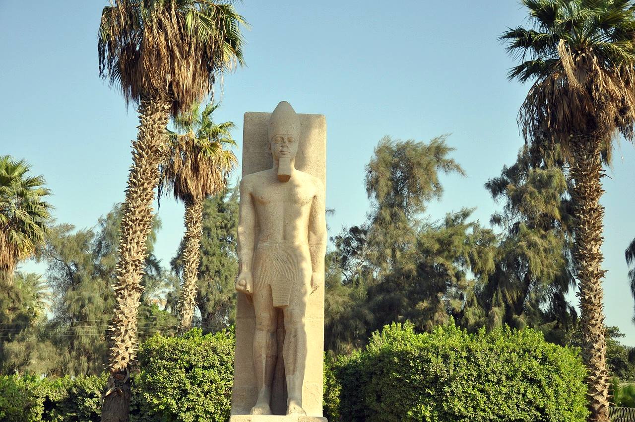 A standing statue of Ramesses II among the palms of Memphis
