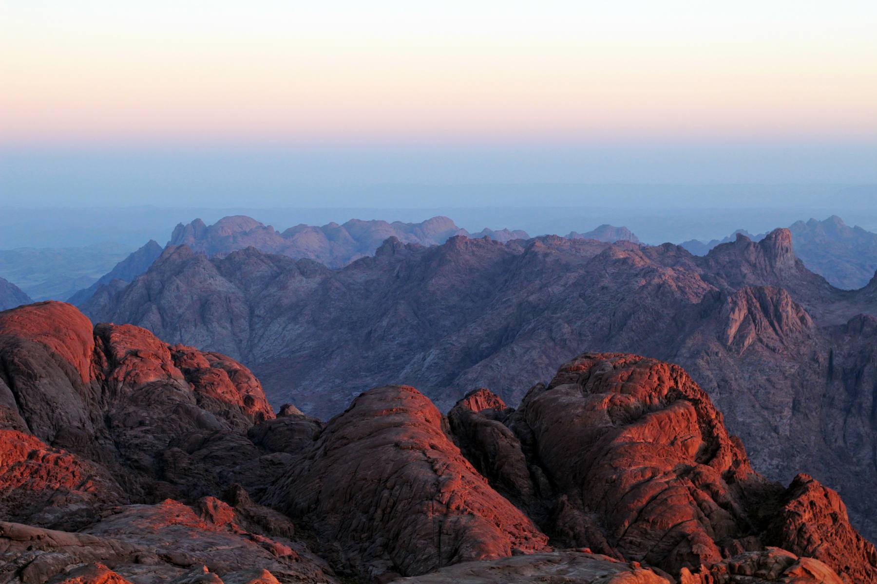 Sunrise igniting the red granite peaks of the Sinai mountains