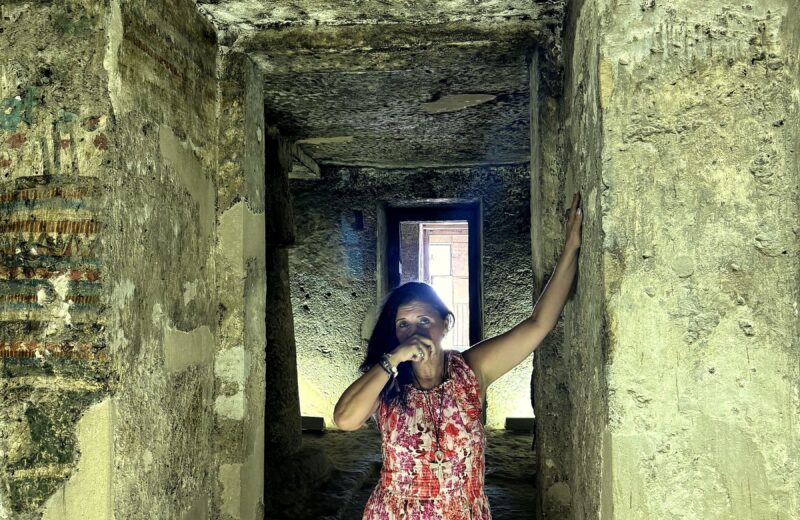 Kristina Mills in the stone corridor of an Amarna tomb