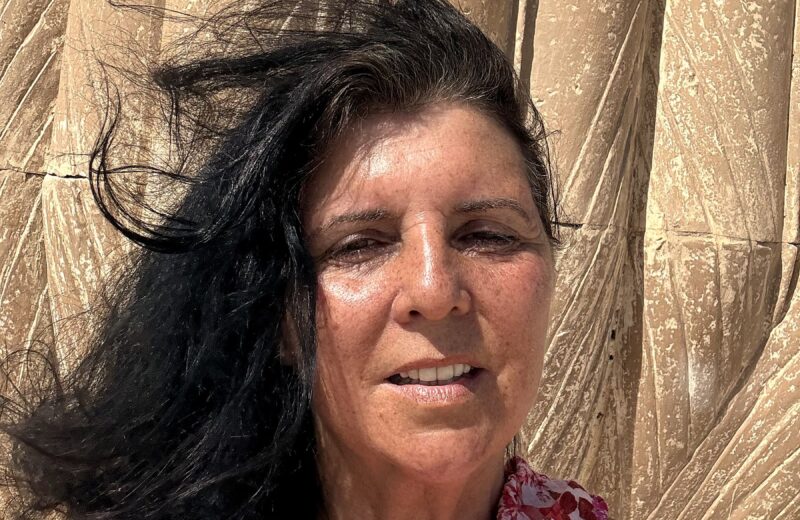 Kristina Mills beside ancient papyrus-bundle columns in Egypt