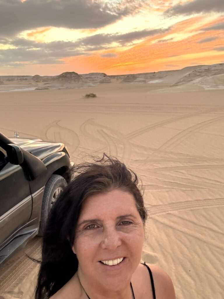 Kristina Mills smiling in the White Desert at sunset