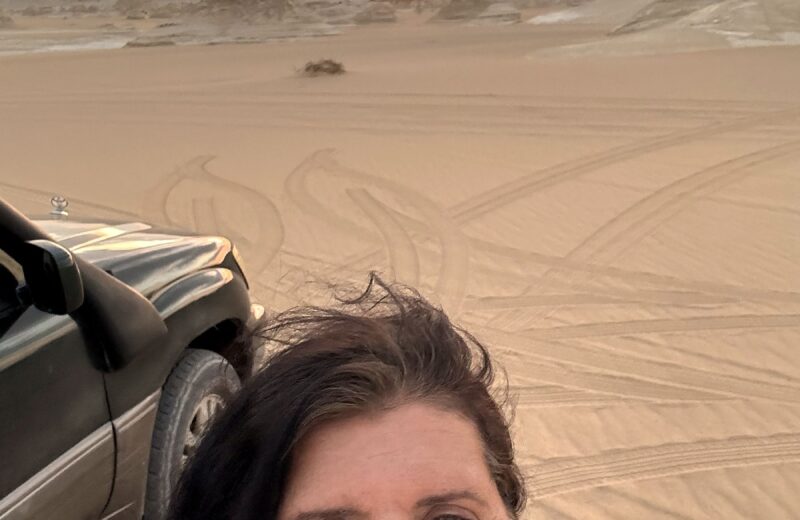 Kristina Mills smiling in the White Desert at sunset